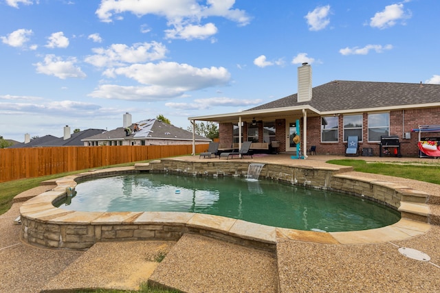 view of pool featuring area for grilling, a patio, and pool water feature