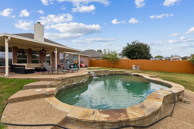 view of swimming pool with a patio, pool water feature, and ceiling fan