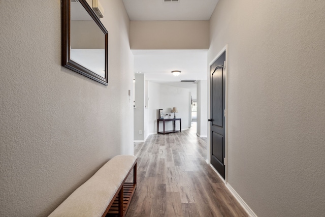 hall with hardwood / wood-style flooring