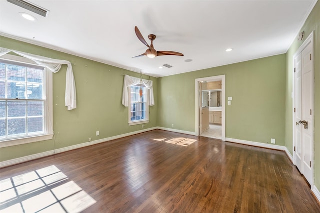 unfurnished room with plenty of natural light, dark wood-type flooring, and ceiling fan