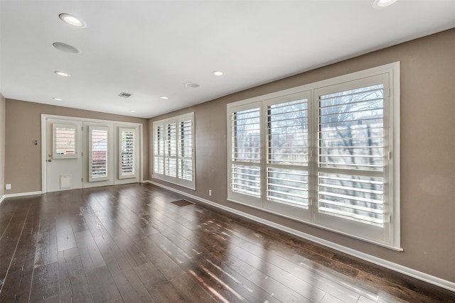 empty room with dark hardwood / wood-style floors