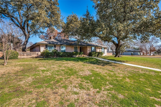 ranch-style home featuring a front yard