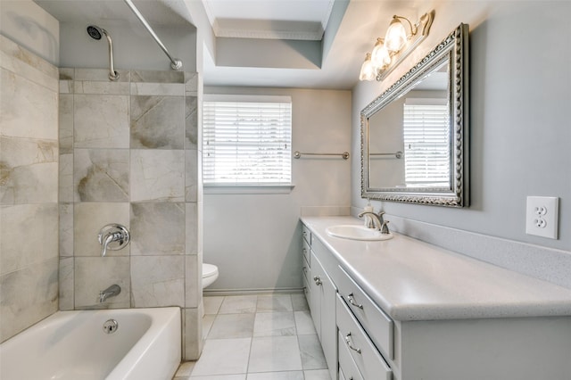 full bathroom featuring tiled shower / bath, vanity, and toilet