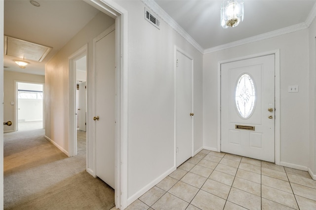 carpeted foyer entrance with crown molding