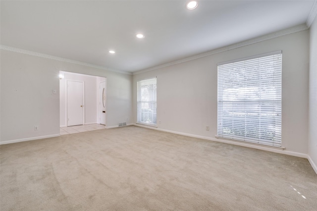 carpeted spare room featuring ornamental molding