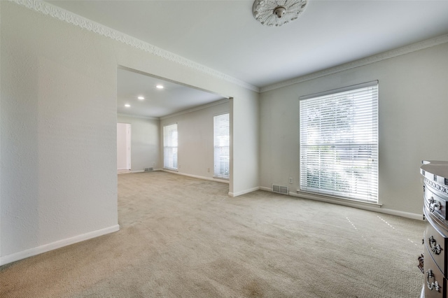 unfurnished living room with light colored carpet and ornamental molding