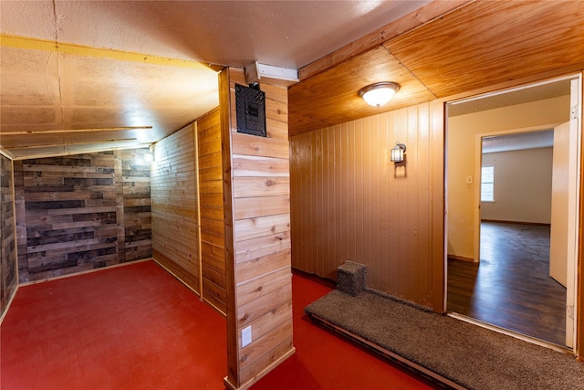 bonus room featuring wooden walls, dark hardwood / wood-style flooring, and wooden ceiling