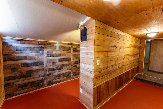 hall featuring wood ceiling and wooden walls