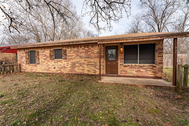 back of property with a patio and a yard