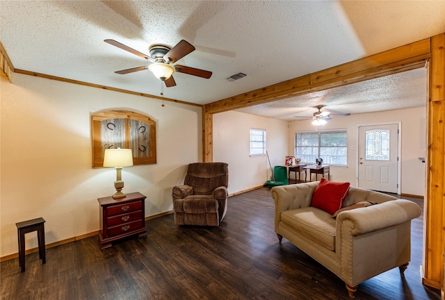 living room with ceiling fan, a textured ceiling, and dark hardwood / wood-style flooring