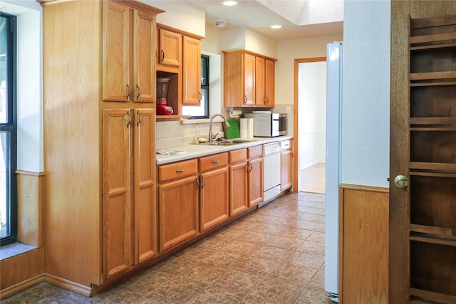 kitchen with white dishwasher and sink