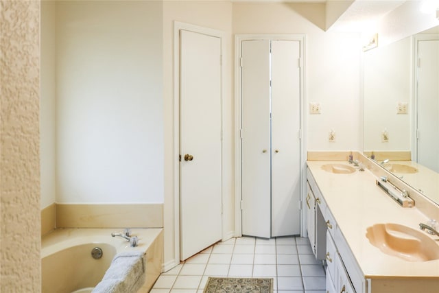 bathroom with vanity, a bath, and tile patterned flooring