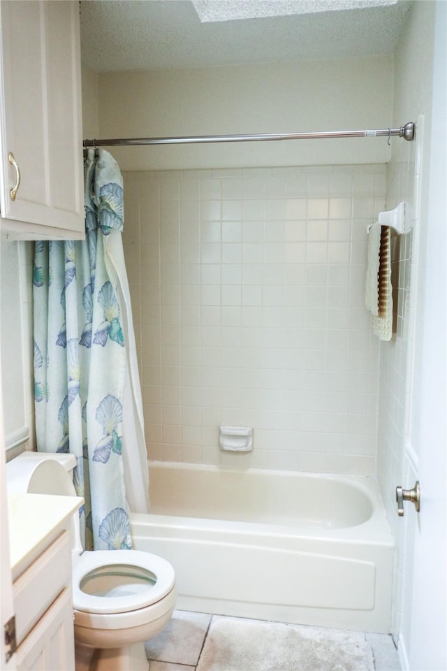 full bathroom with tile patterned floors, toilet, a textured ceiling, vanity, and shower / bath combo