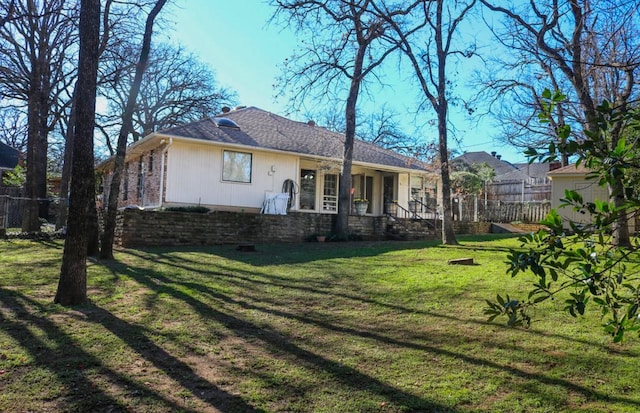 rear view of house with a yard