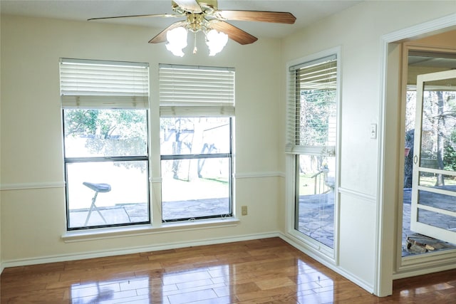 doorway featuring wood-type flooring and ceiling fan