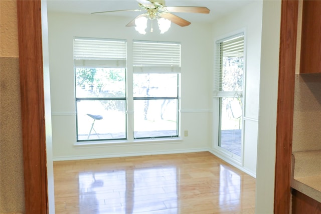 spare room with ceiling fan and light wood-type flooring