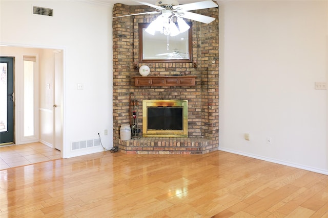 unfurnished living room featuring a fireplace and light hardwood / wood-style flooring