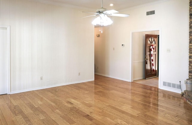 empty room featuring ceiling fan, ornamental molding, and light hardwood / wood-style floors