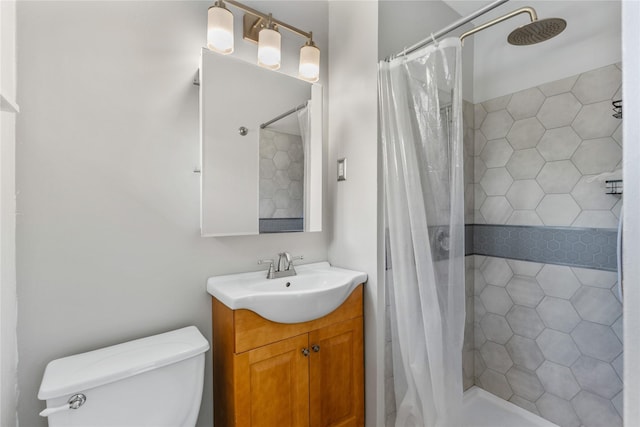 bathroom featuring walk in shower, vanity, and toilet