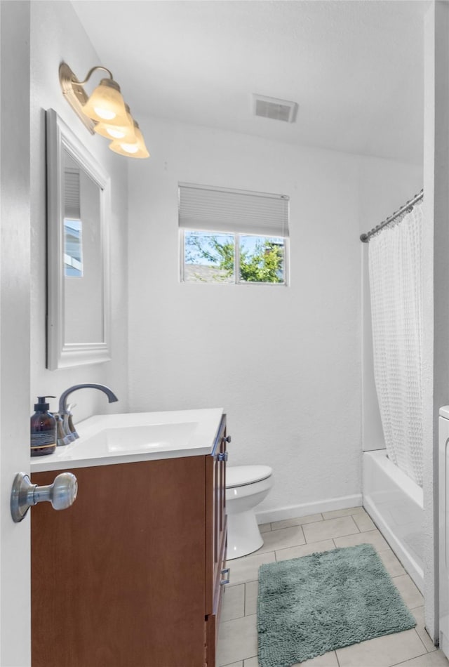 full bathroom featuring tile patterned flooring, vanity, toilet, and shower / bath combo with shower curtain