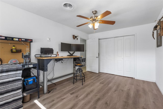 office space featuring ceiling fan and light wood-type flooring