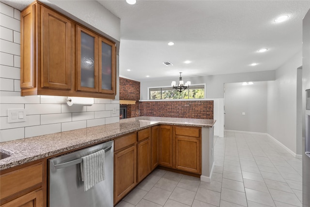 kitchen with light tile patterned floors, stainless steel dishwasher, kitchen peninsula, light stone countertops, and decorative backsplash