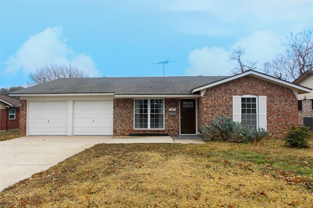 ranch-style house featuring a garage and a front lawn