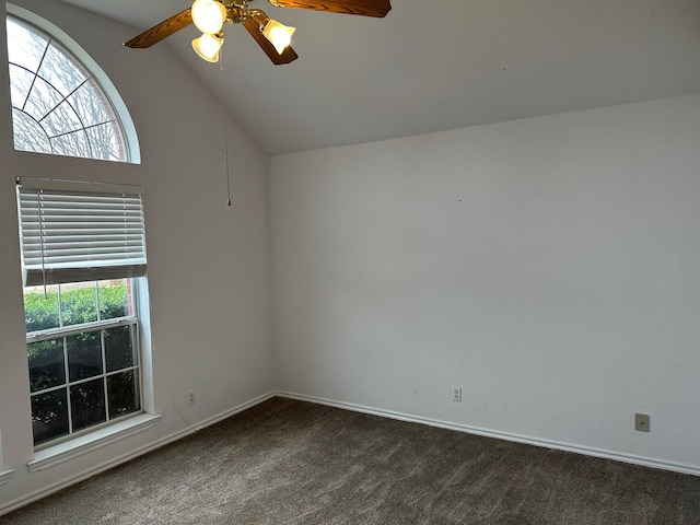 unfurnished room with high vaulted ceiling, dark carpet, and a ceiling fan