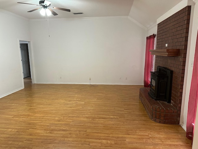 unfurnished living room featuring light wood-style flooring, vaulted ceiling, and crown molding