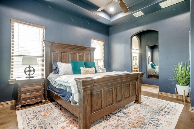 bedroom with light hardwood / wood-style floors and ceiling fan