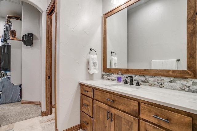 bathroom featuring vanity and decorative backsplash