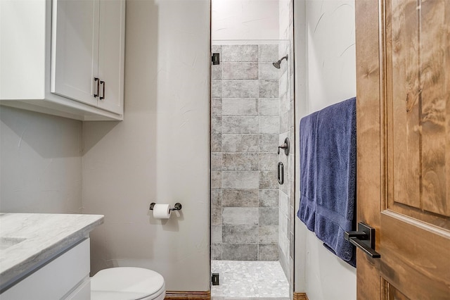 bathroom with vanity, an enclosed shower, and toilet