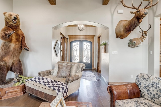 entrance foyer featuring dark hardwood / wood-style floors, french doors, and a chandelier