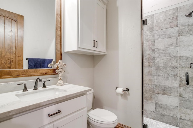 bathroom featuring vanity, an enclosed shower, and toilet