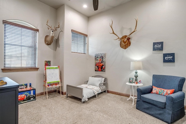 living area featuring ceiling fan and carpet flooring