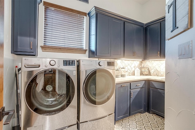 laundry area featuring washing machine and dryer and cabinets