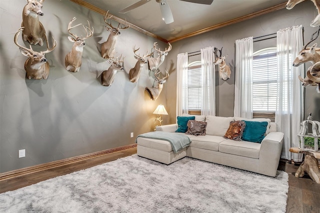 living room with crown molding, hardwood / wood-style floors, and ceiling fan