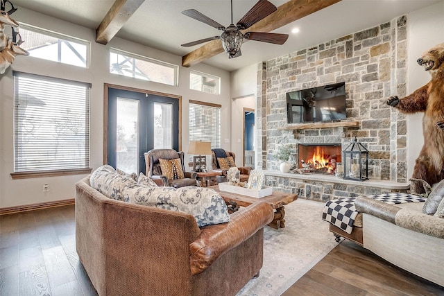 living room with hardwood / wood-style flooring, a healthy amount of sunlight, and beamed ceiling