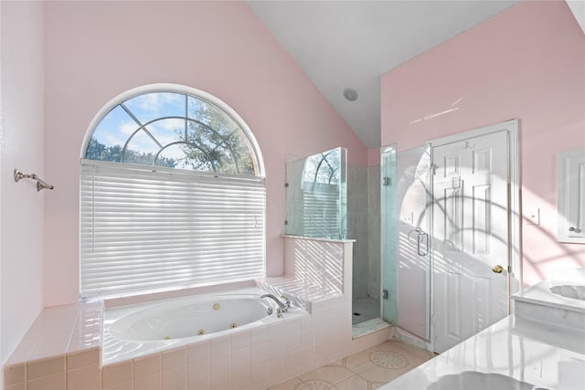 bathroom with lofted ceiling and independent shower and bath