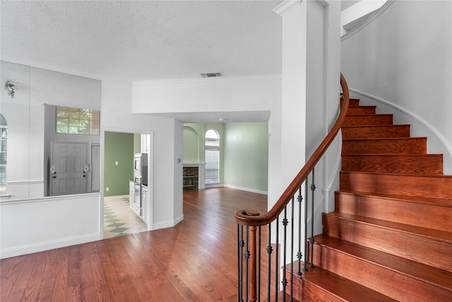 entryway with hardwood / wood-style flooring and a textured ceiling