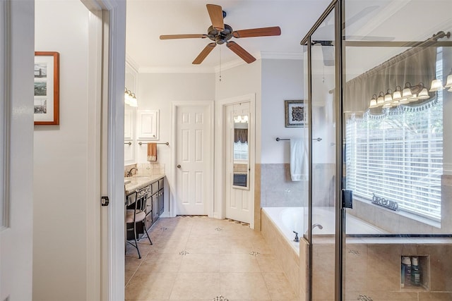 bathroom featuring crown molding, a healthy amount of sunlight, and vanity