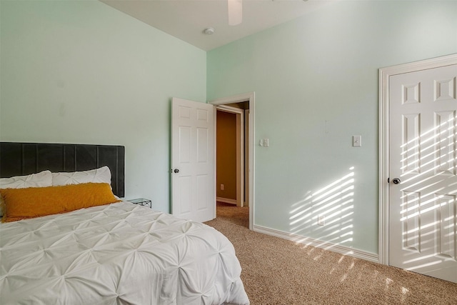 carpeted bedroom featuring vaulted ceiling and ceiling fan