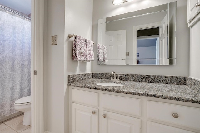 bathroom with tile patterned flooring, vanity, a shower with curtain, and toilet