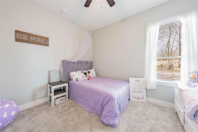 carpeted bedroom with ceiling fan and multiple windows