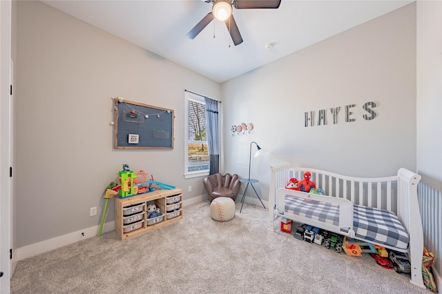 carpeted bedroom with a nursery area and ceiling fan