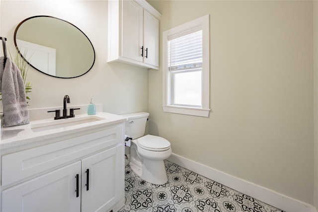 bathroom featuring vanity, tile patterned floors, and toilet