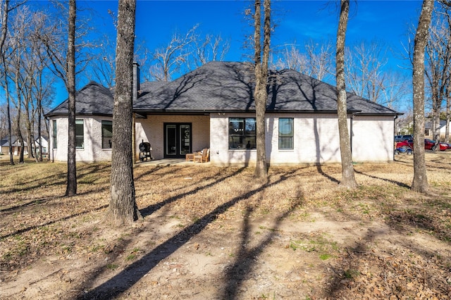 back of house with a lawn