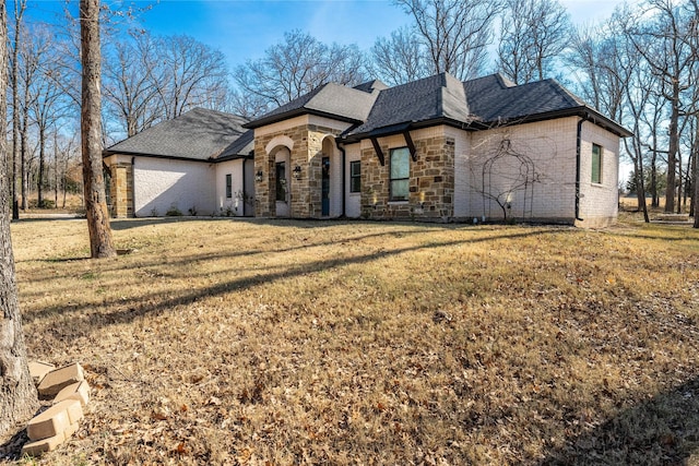 french country style house featuring a front yard