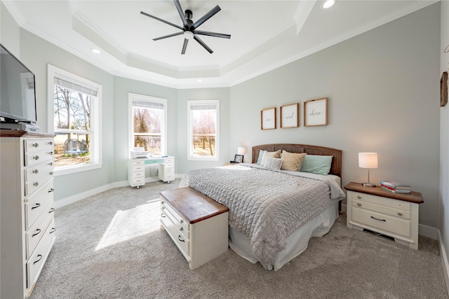 carpeted bedroom featuring a raised ceiling, crown molding, and ceiling fan