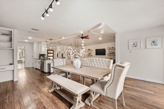 dining area featuring lofted ceiling, hardwood / wood-style floors, and ceiling fan